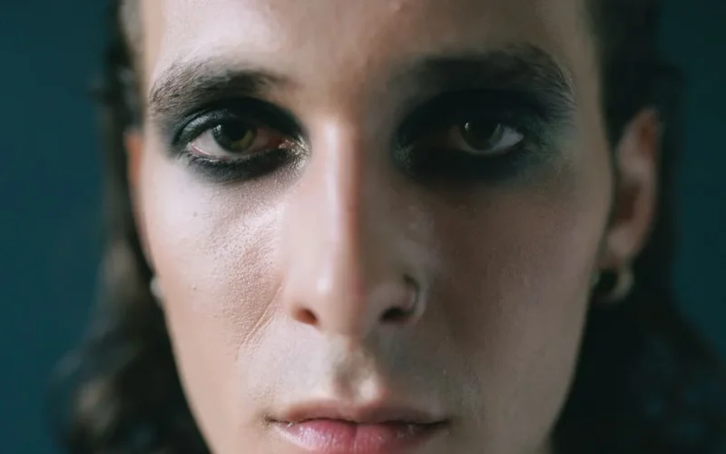 Intense close-up of a person with bold, dramatic eye makeup.