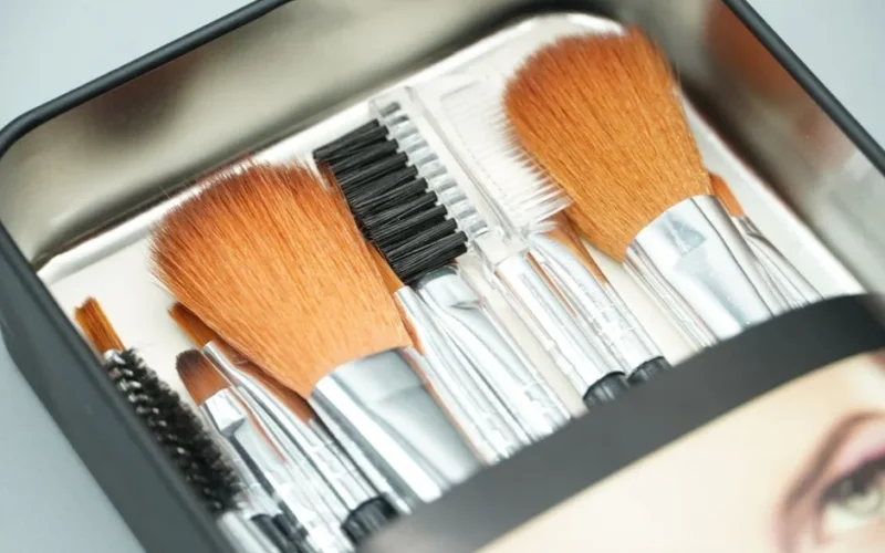A close-up view of a set of professional makeup brushes inside a sleek box, ideal for beauty routines.